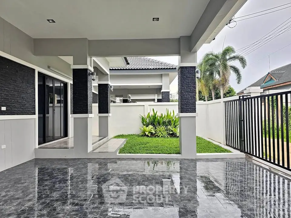 Modern home entrance with sleek design and lush garden