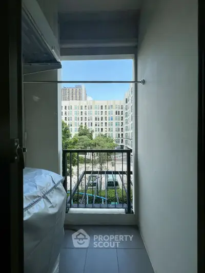 Charming balcony view with urban landscape and greenery, perfect for relaxation and enjoying city life.