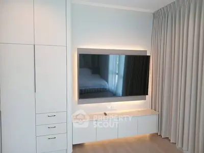 Modern living room with sleek TV setup and elegant curtains