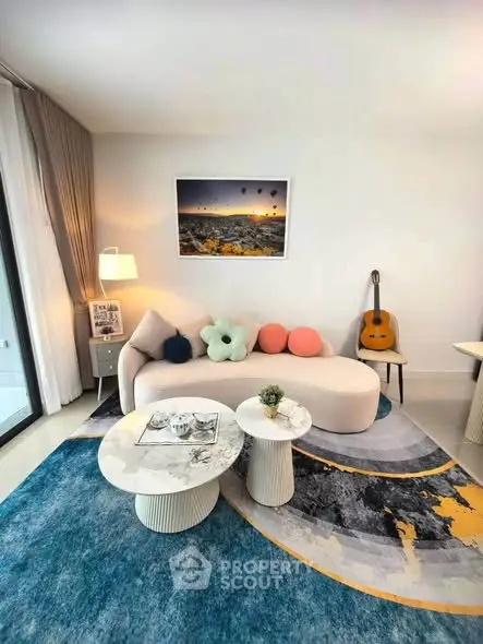 Stylish living room with modern decor, plush sofa, and artistic rug, perfect for relaxation and entertainment.