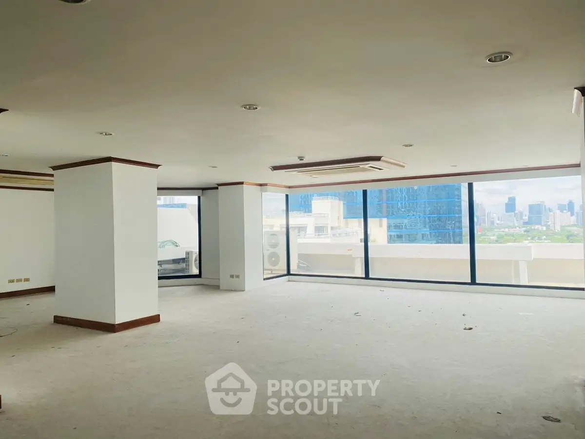Spacious corner unit with floor-to-ceiling windows offering stunning city views.