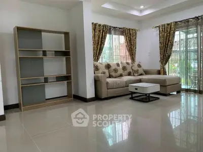Spacious living room with modern sofa and elegant curtains, perfect for relaxation and entertaining.