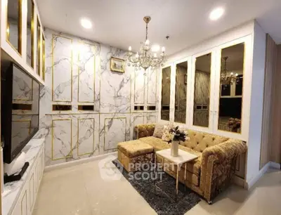Luxurious living room with elegant marble walls and plush gold sofa