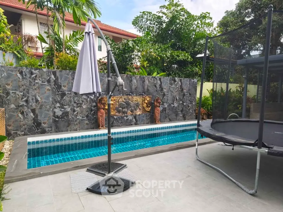 Luxurious backyard with private pool and trampoline, perfect for family entertainment and relaxation.
