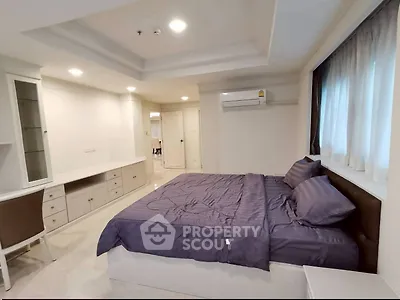 Spacious bedroom with modern decor and natural light