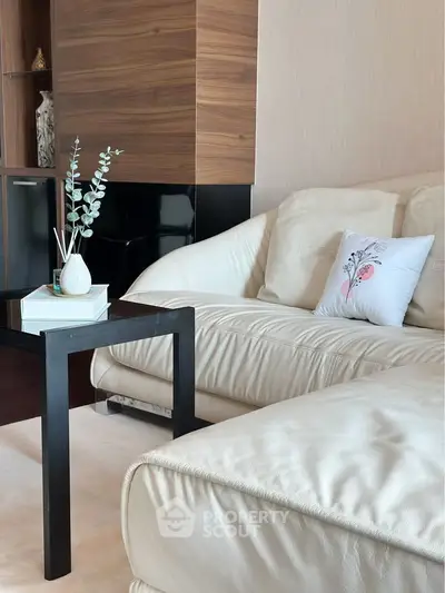 Luxurious modern living room with plush white sofa and elegant decor, perfect for relaxation and style.
