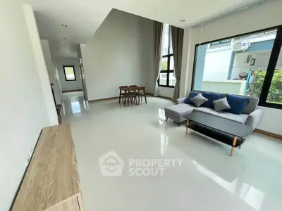Spacious modern living room with large windows and stylish furniture