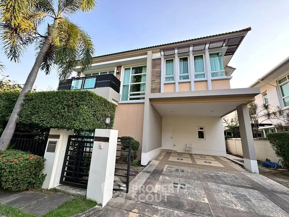 Modern two-story house with large windows and spacious driveway in a serene neighborhood.