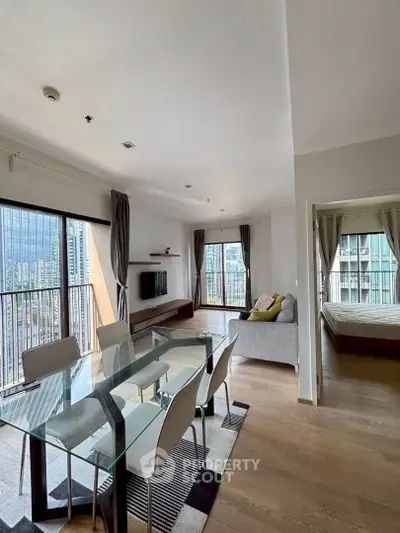 Modern open-plan living room with dining area and city view