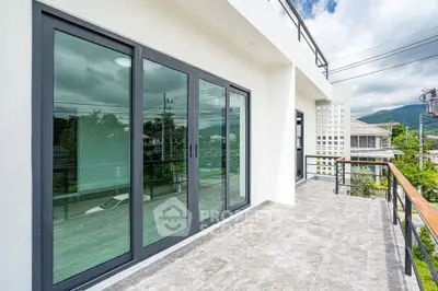 Spacious balcony with mountain view and modern glass doors
