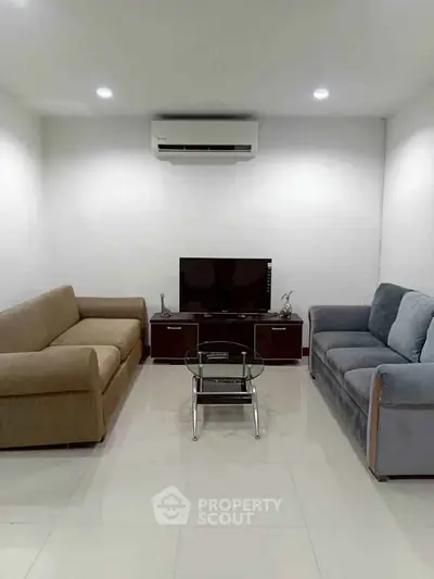 Modern living room with sleek furniture and air conditioning, perfect for relaxation and entertainment.