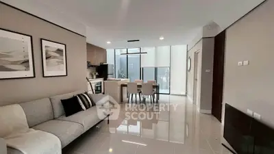 Modern open-plan living and dining area with sleek design and natural light.