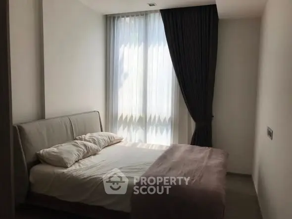 Cozy bedroom with soft lighting and elegant curtains, perfect for relaxation.