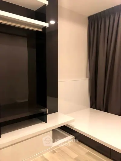 Modern minimalist bedroom with sleek built-in storage and elegant curtains