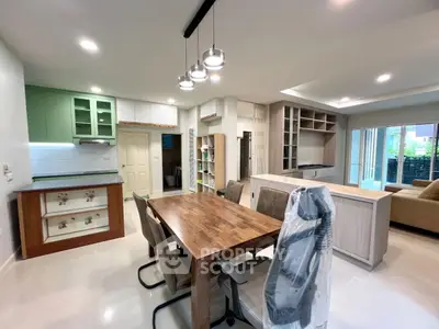 Modern open-plan living and dining area with stylish furniture and ample natural light.