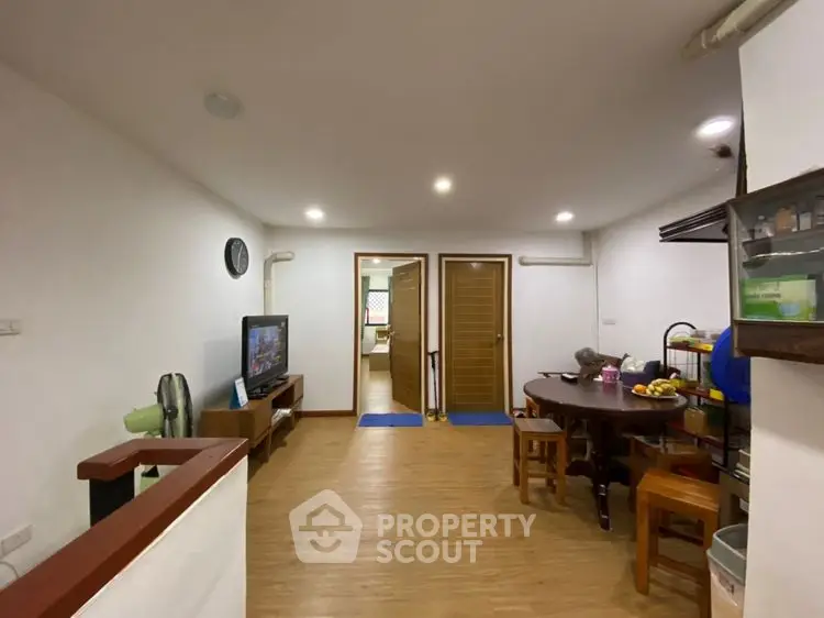 Spacious living area with wooden flooring and modern furnishings