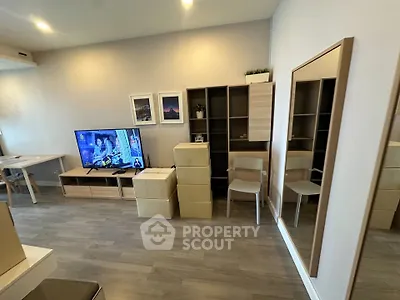 Modern living room with stylish furniture and wall-mounted TV, perfect for relaxation and entertainment.
