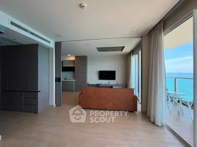 Spacious living room with ocean view and large balcony in modern apartment
