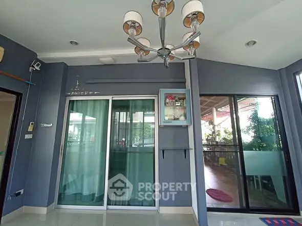 Spacious modern living room with large windows and stylish lighting