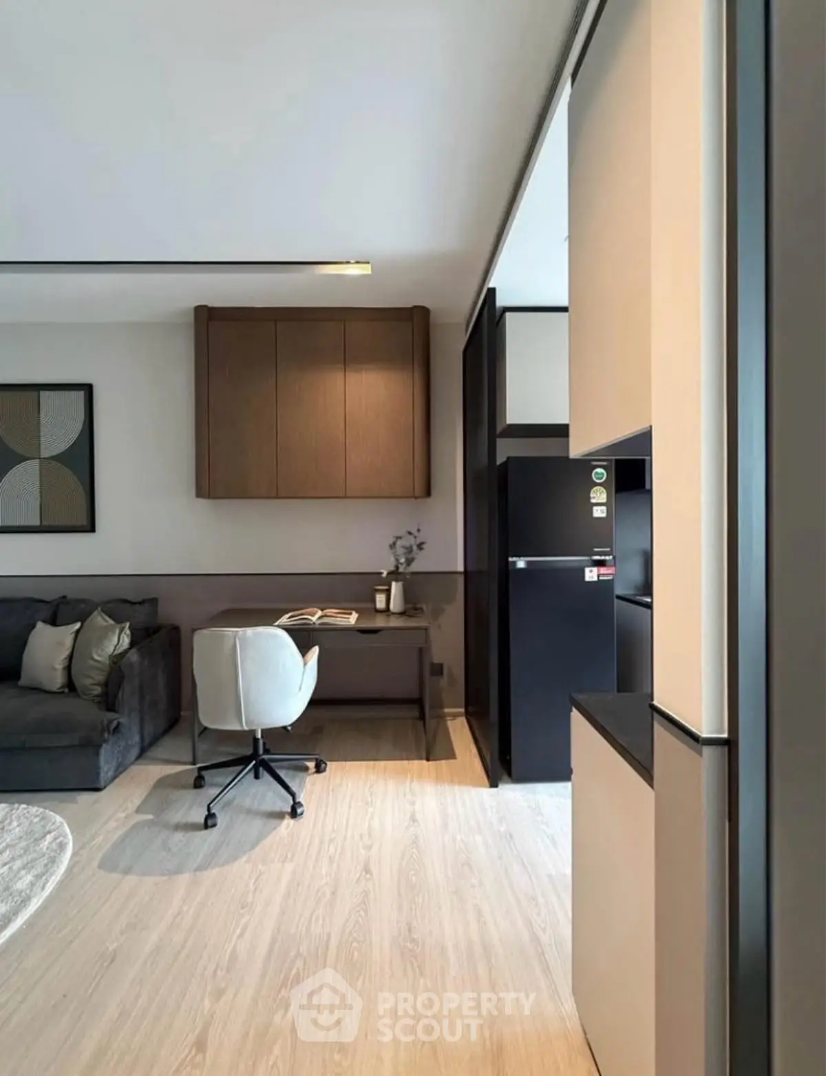 Modern living room with sleek furniture and stylish decor, featuring a cozy study nook and contemporary design.