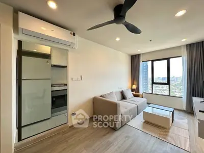 Modern living room with city view, featuring sleek furniture and integrated kitchen appliances.