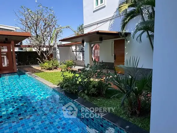 Luxurious villa exterior with private pool and lush garden, perfect for relaxation and entertainment.