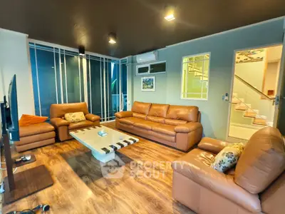 Spacious living room with leather sofas and modern decor