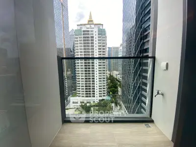Stunning city view from a high-rise balcony with modern architecture.