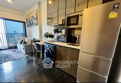 Modern apartment with open kitchen, cozy living area, and city view balcony.