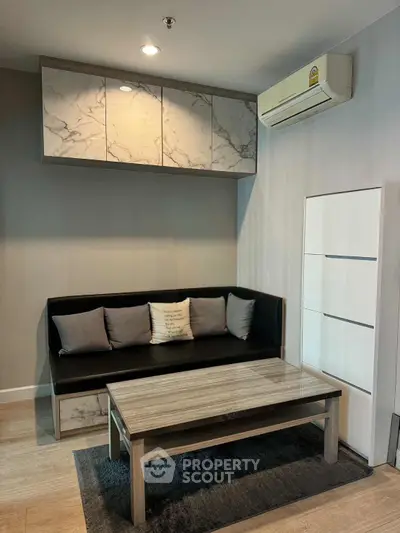 Modern living room with sleek furniture and air conditioning, perfect for urban living.