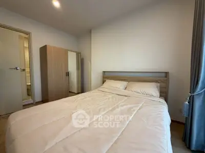 Cozy bedroom with modern furniture and en-suite bathroom in a stylish apartment.