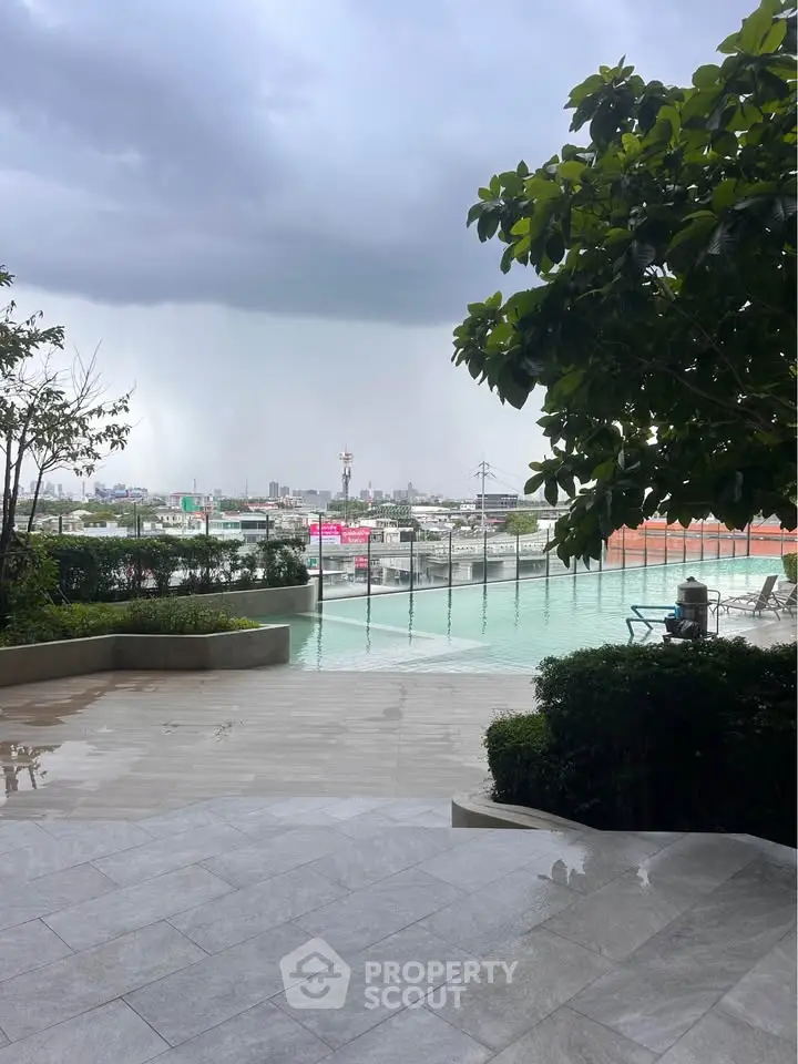 Luxurious rooftop pool with stunning city views and lush greenery, perfect for relaxation and leisure.