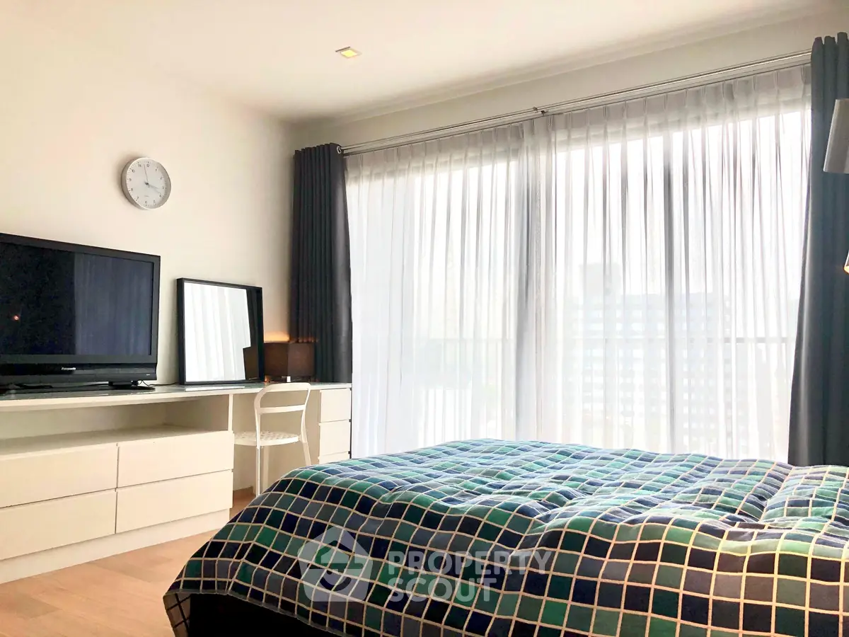 Bright and modern bedroom with large window and stylish decor