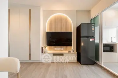 Modern living room with stylish TV setup and sleek kitchen appliances