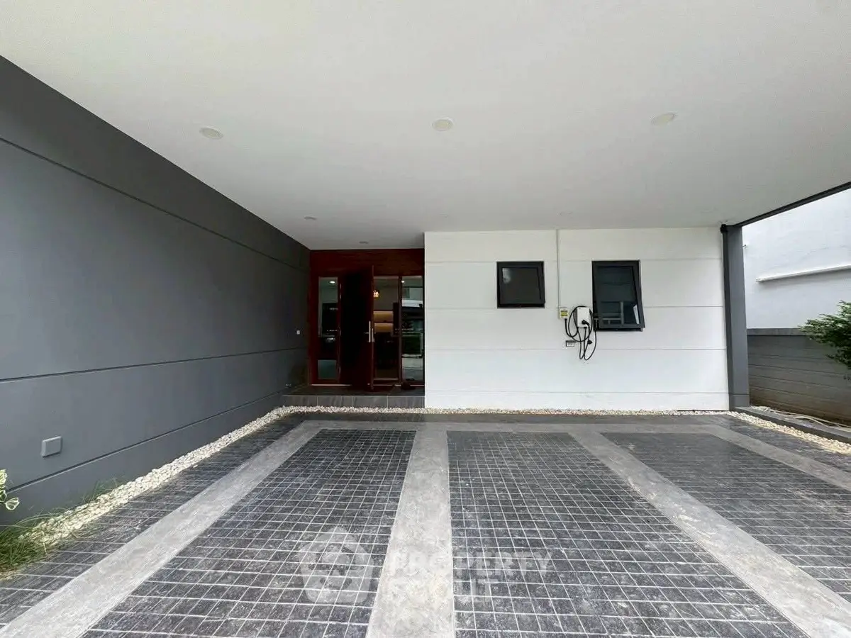 Modern covered parking area with sleek design and tiled flooring in a contemporary building.