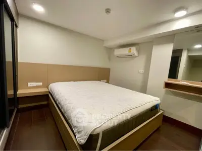 Modern bedroom with sleek design and air conditioning in a stylish apartment.