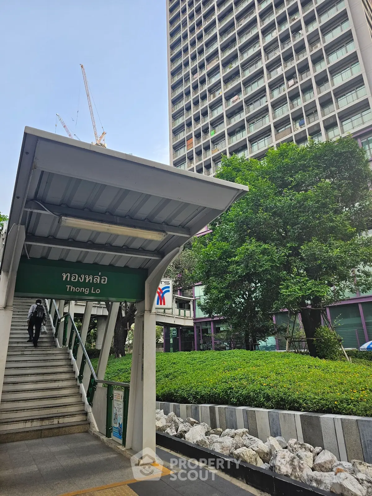 Modern high-rise building near Thong Lo station with lush greenery and urban appeal.