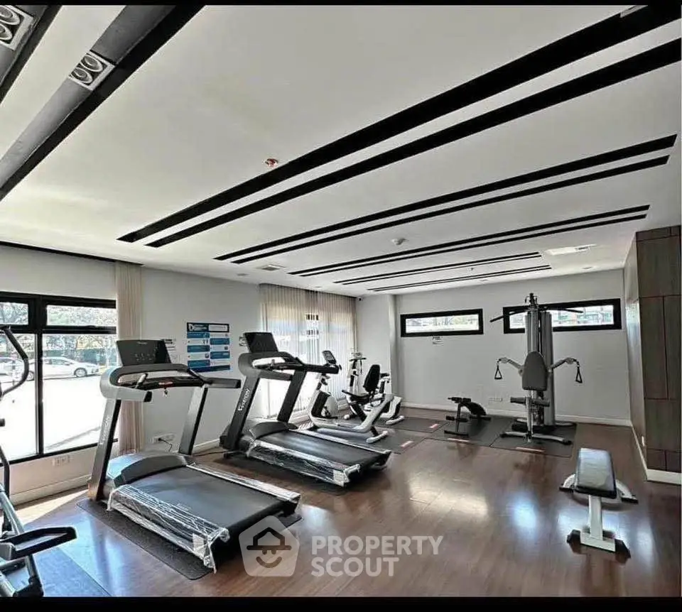 Modern gym with state-of-the-art equipment and sleek design in a real estate property.