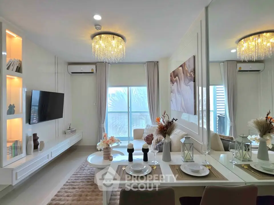 Luxurious modern living room with elegant decor and dining area, featuring a chandelier and large window view.