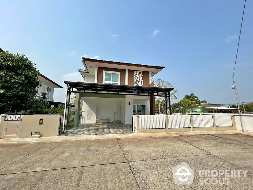 Modern two-story house with spacious driveway and gated entrance