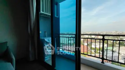 Stunning high-rise balcony with panoramic city view and modern glass doors.