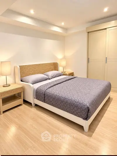 Spacious bedroom with modern design and cozy lighting, featuring a comfortable bed and stylish decor.