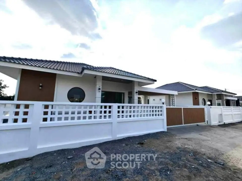 Modern single-story house with stylish design and spacious driveway