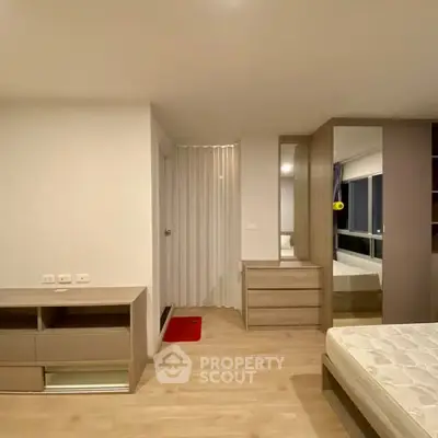 Spacious bedroom with modern furniture and ample natural light