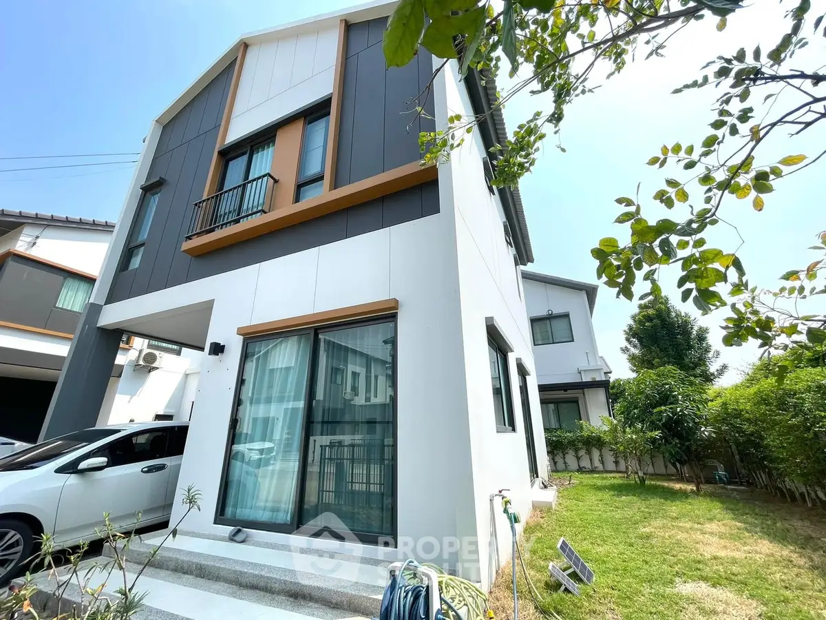 Modern two-story house with sleek design and lush garden