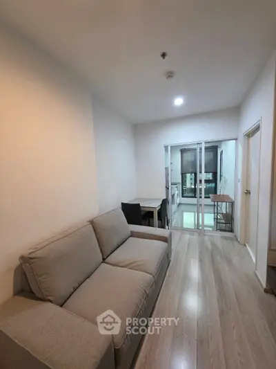 Modern living room with cozy sofa and open kitchen layout