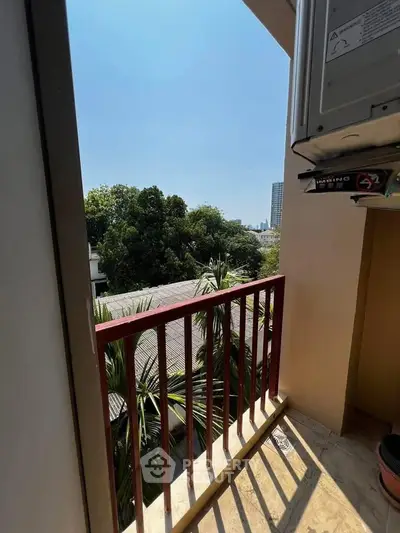 Charming balcony with lush green view, perfect for relaxation and enjoying nature's tranquility.