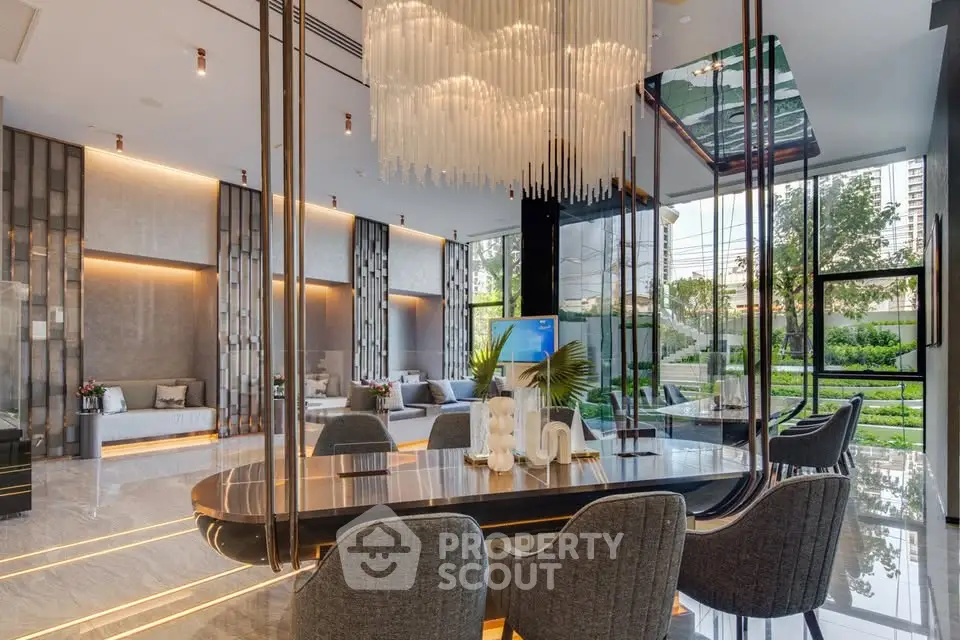 Luxurious modern living room with elegant chandelier and garden view, perfect for upscale living.