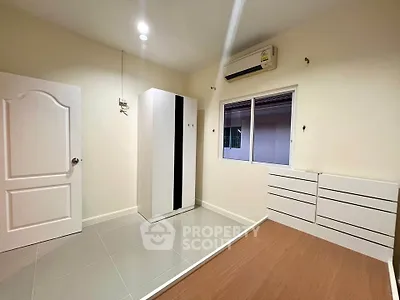 Spacious bedroom with modern wardrobe and air conditioning, perfect for comfortable living.