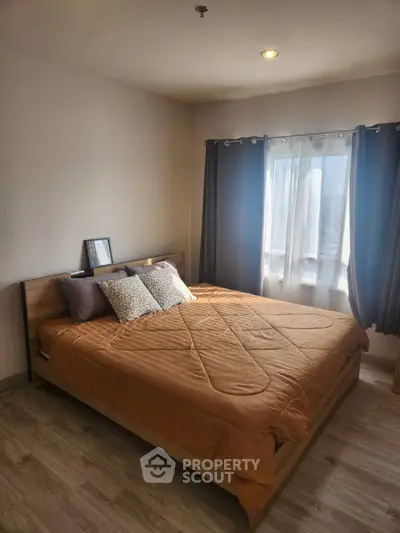 Cozy bedroom with natural light and modern decor, perfect for relaxation and comfort.
